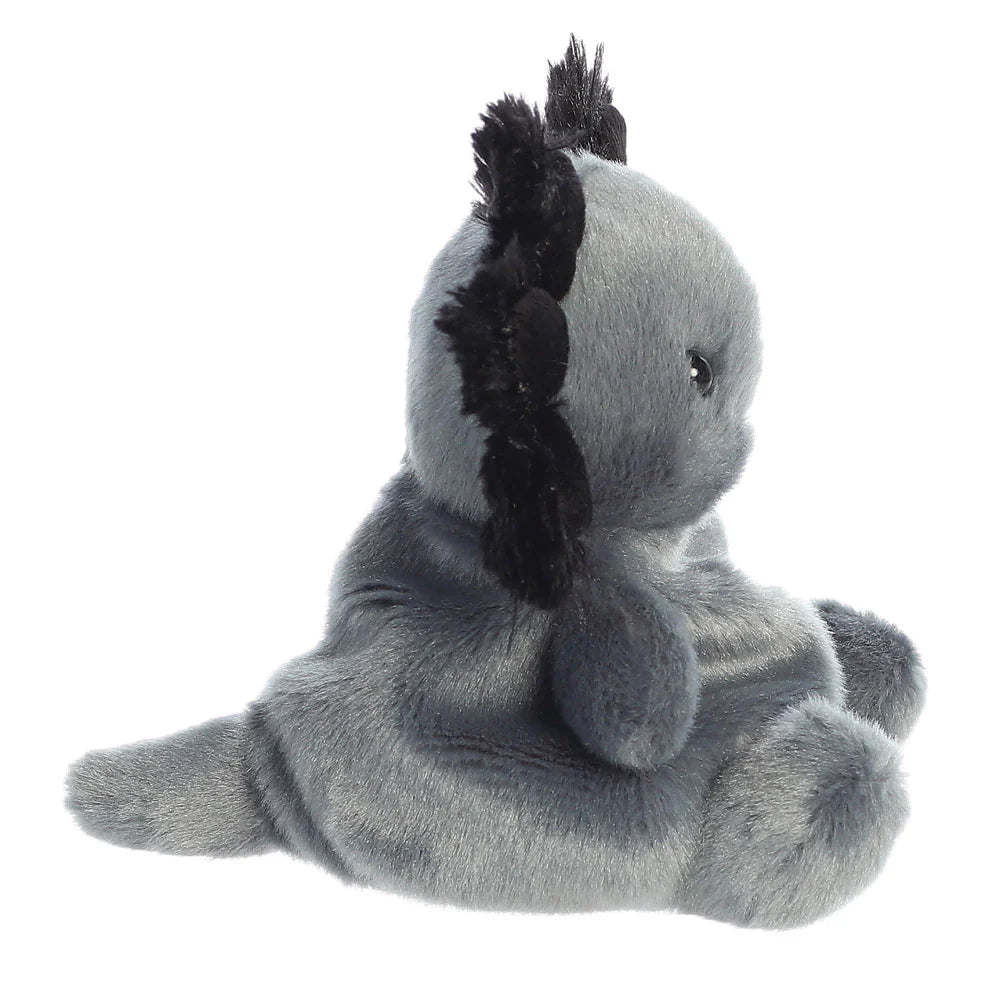 Plush toy koala with a black feather on a white background