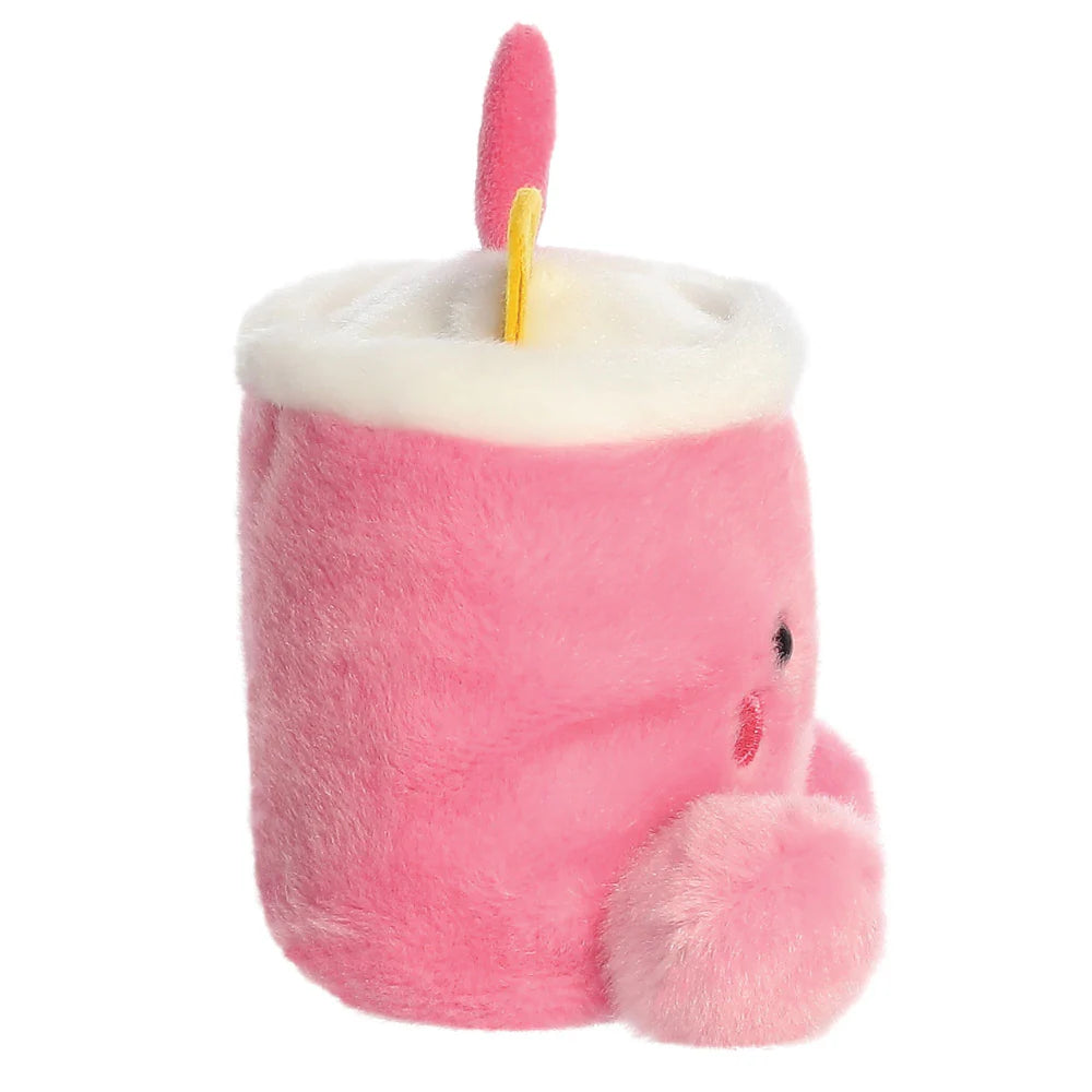 Plush toy resembling a pink candle with a white wick on a white background