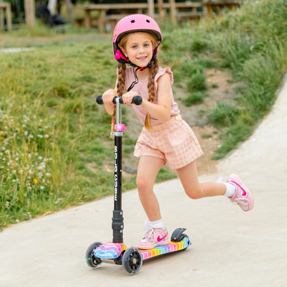 Child riding a scooter with a helmet on a path outdoors