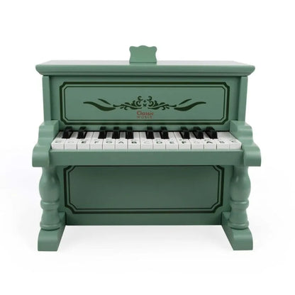 Green toy piano with keyboard on a white background