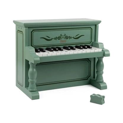 Green toy piano with white and black keys on a white background