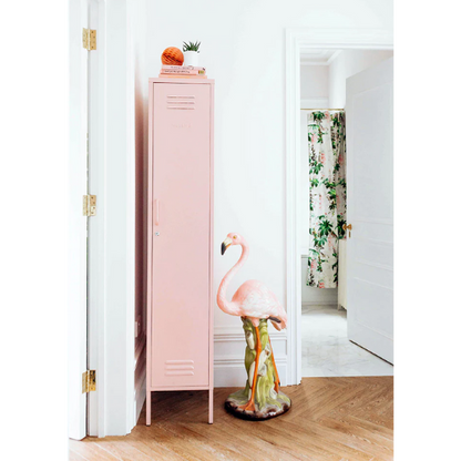 Pink locker with a flamingo design in a room with floral curtains.
