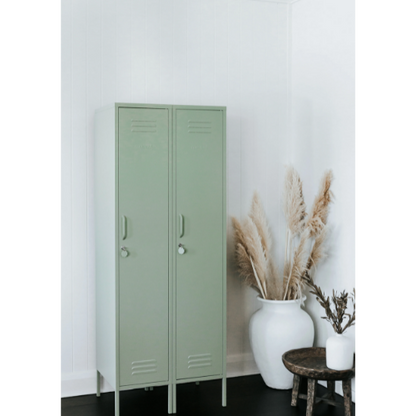 Green metal locker against a white wall with decorative plants.