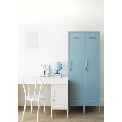 Light blue locker next to a white desk with a chair in a room.