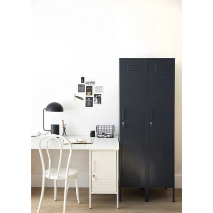 Navy blue locker next to a white desk with a chair in a room.