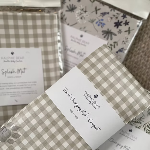 Checkered changing mats with labels on a textured surface