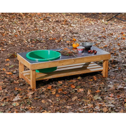 Wooden bench with pet bowls on a leaf-covered ground