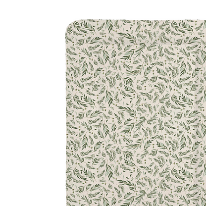 Fabric swatch with green leaf pattern on a beige background