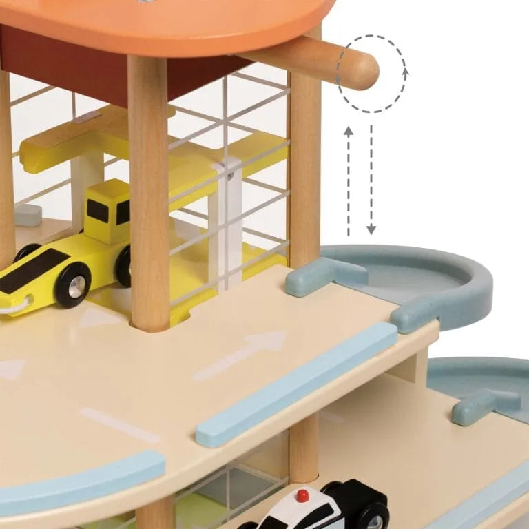 Toy parking garage with cars on a white background