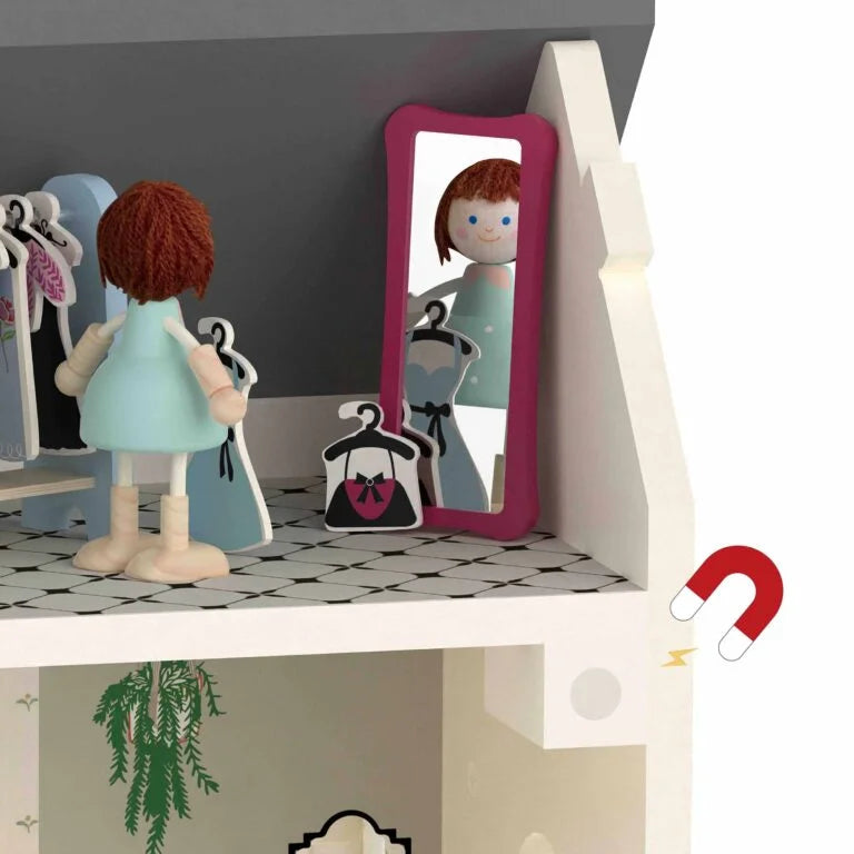 Toy figure of a girl looking into a mirror on a shelf with a plant below.