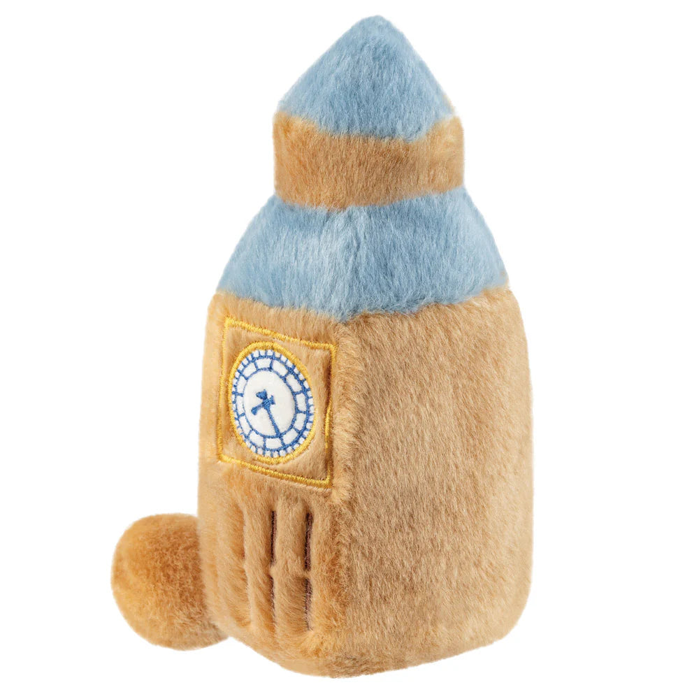 Plush toy resembling a rocket with a blue top and brown body on a white background