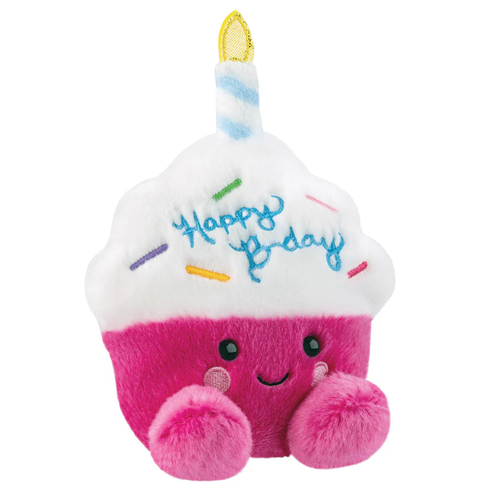 Plush toy shaped like a birthday cupcake with a candle and 'Happy Birthday' text on a white background.