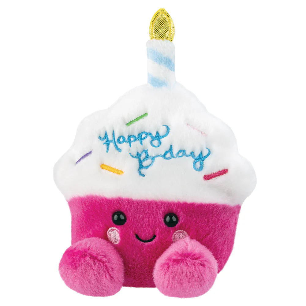 Plush toy shaped like a birthday cake with a candle and 'Happy Birthday' text on a white background