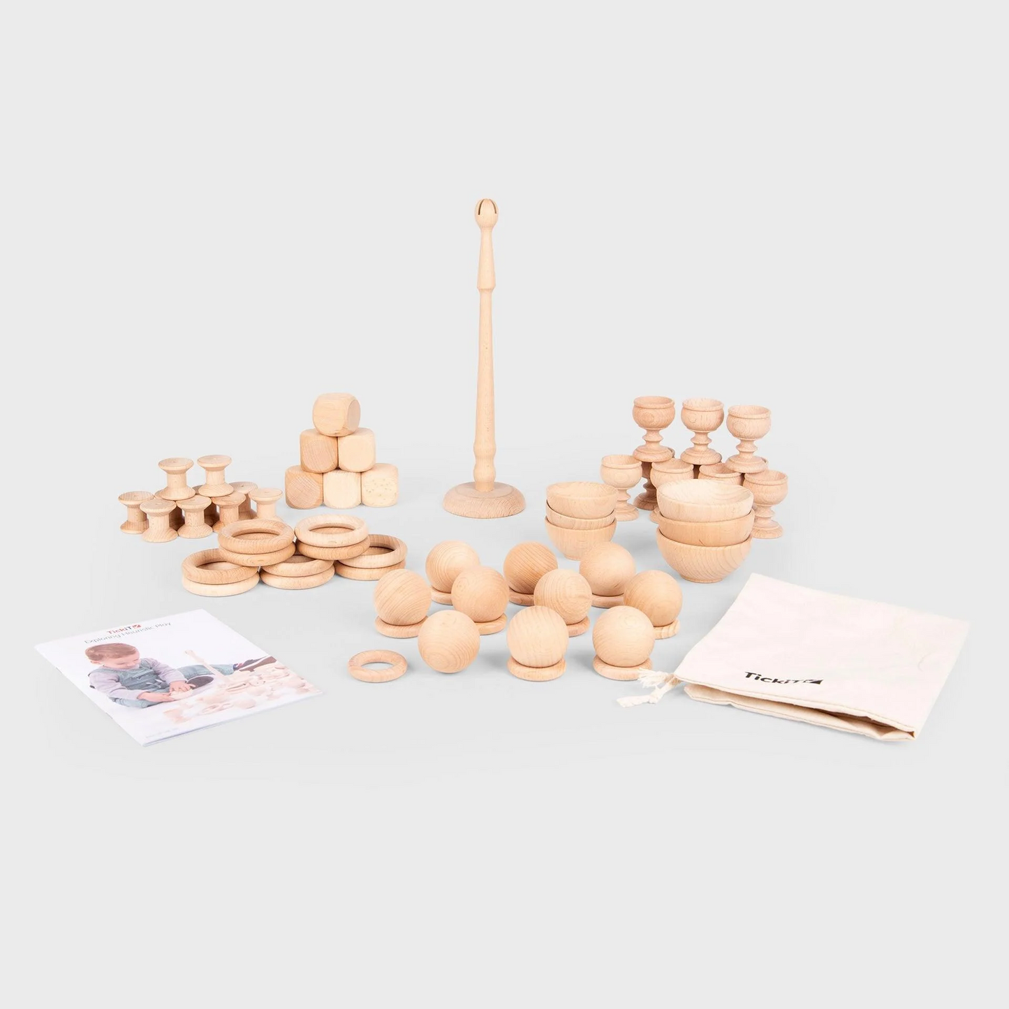 Set of wooden toys including rings and cups on a light gray background