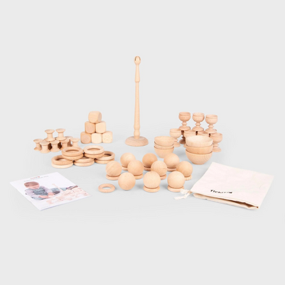 Set of wooden toys including rings and cups on a light gray background