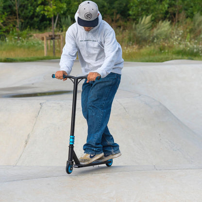 Person riding a scooter at a skate park