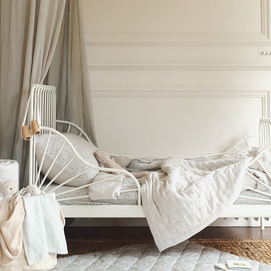 Children's bed with canopy in a softly lit bedroom