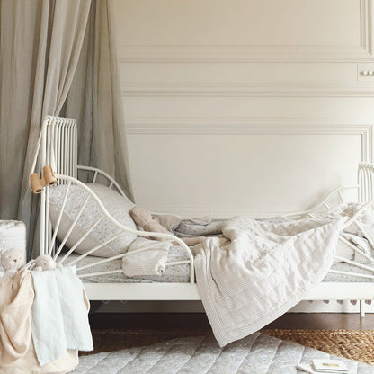 Children's bed with canopy in a softly lit bedroom