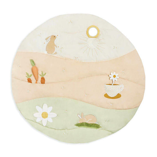 Round cushion with embroidered designs of bunnies, carrots, and flowers on a white background