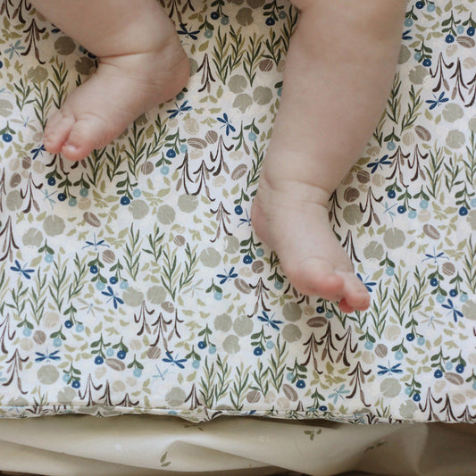 Baby feet on a floral-patterned fabric