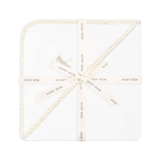 White napkin with gold border and 'Avery Row' text on a white background