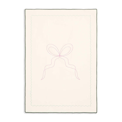 Rectangular quilt with a bow design on a white background