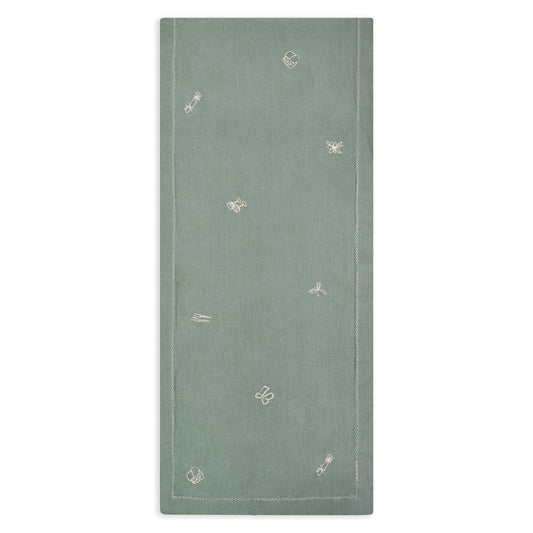 Green fabric with small white patterns on a white background