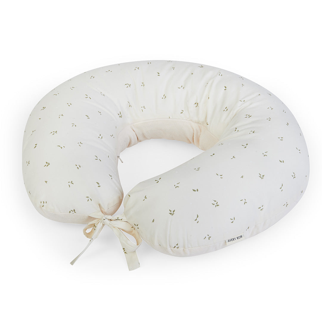 White baby boppy pillow with subtle pattern on a white background