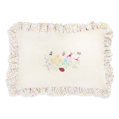 Decorative pillow with floral border and embroidered design on a white background