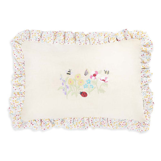 Decorative pillow with floral border and embroidered design on a white background
