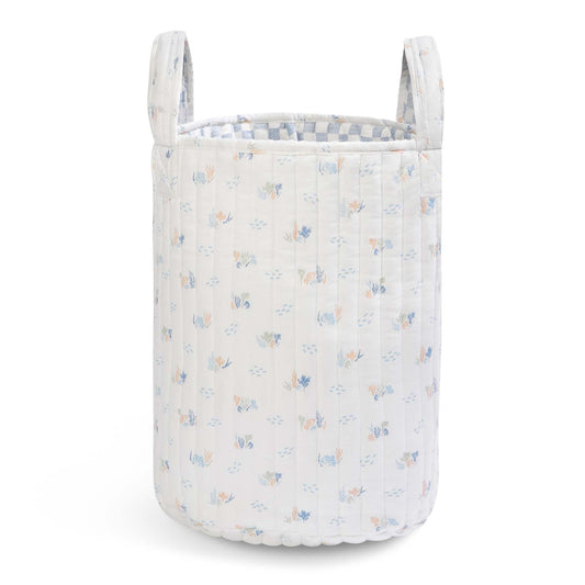 Floral-patterned laundry basket on a white background