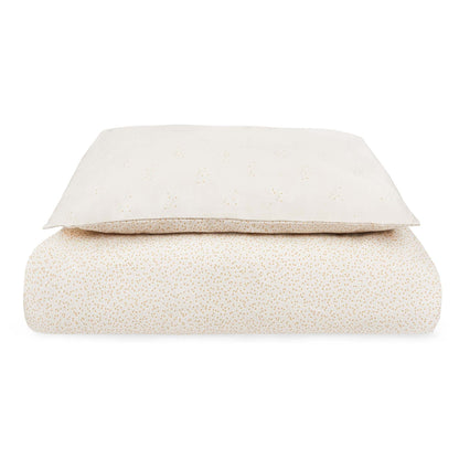 Folded beige blanket on a white background