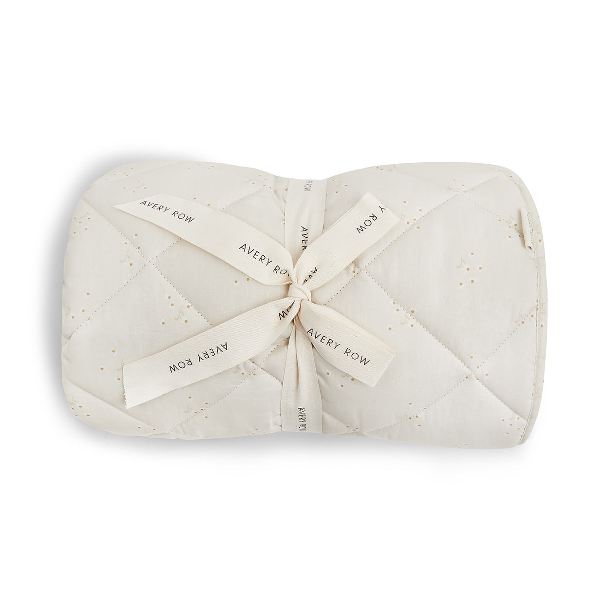 Folded quilt with 'Avery Row' branding on a white background