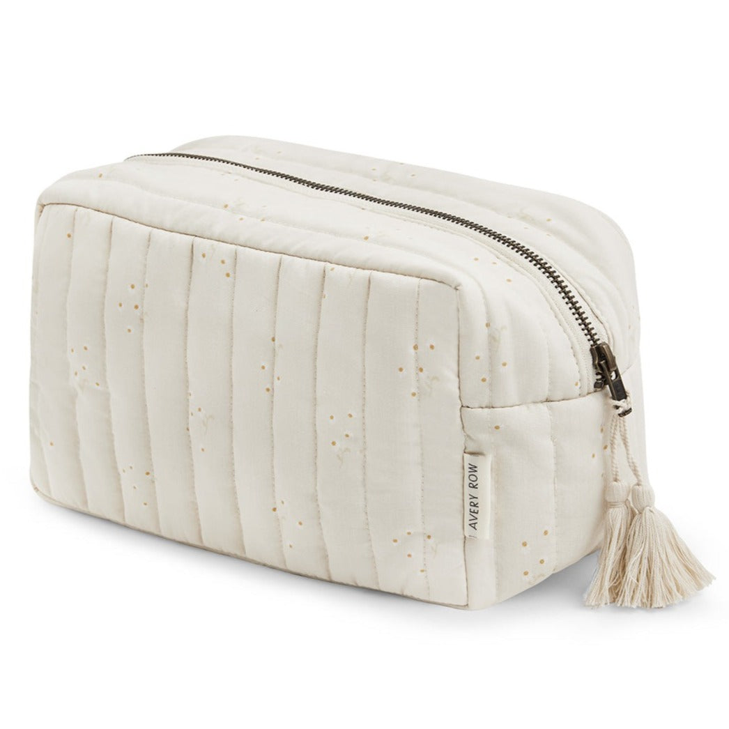 Quilted toiletry bag with zipper and tassel on a white background