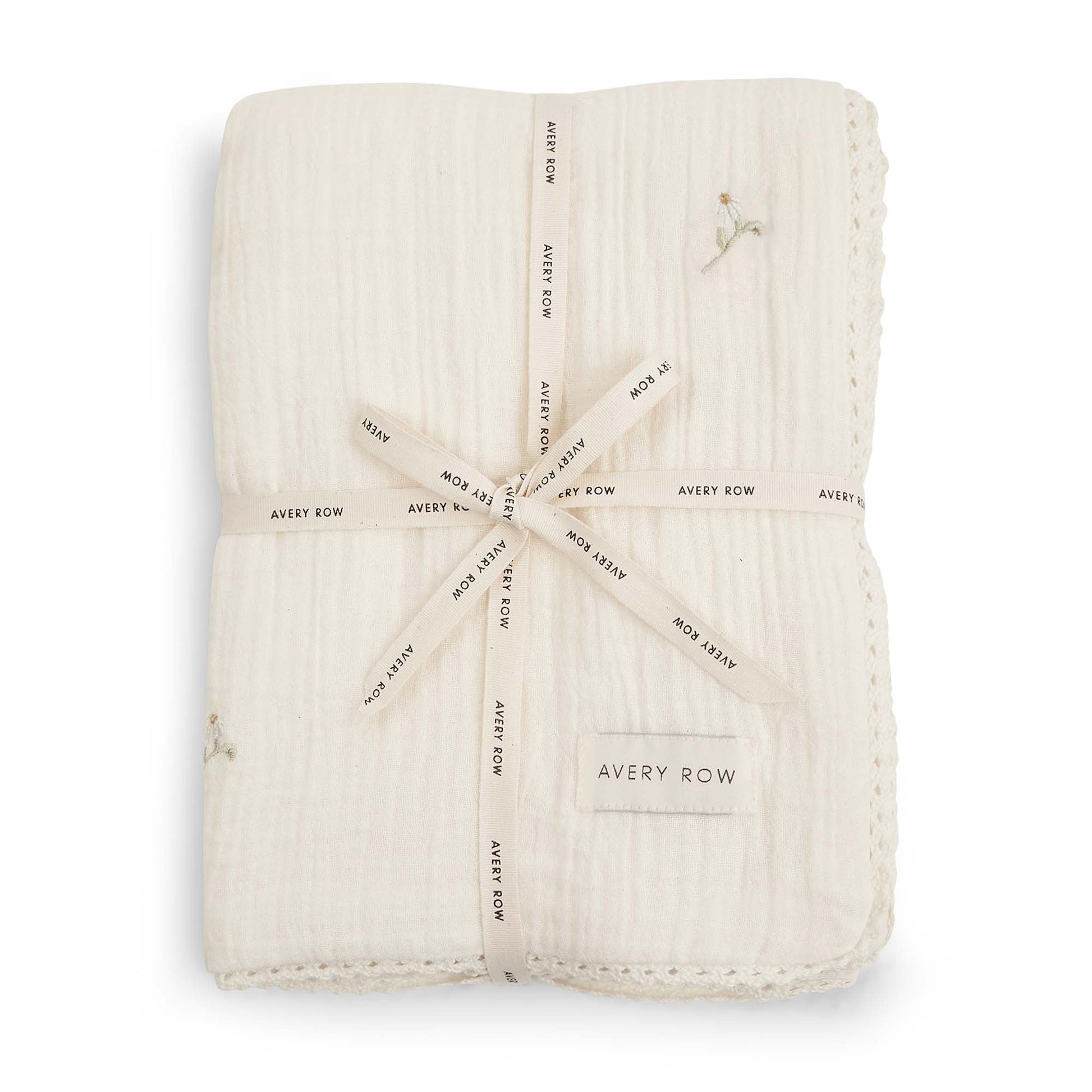 Folded beige fabric swaddle with 'Avery Row' branding on a white background