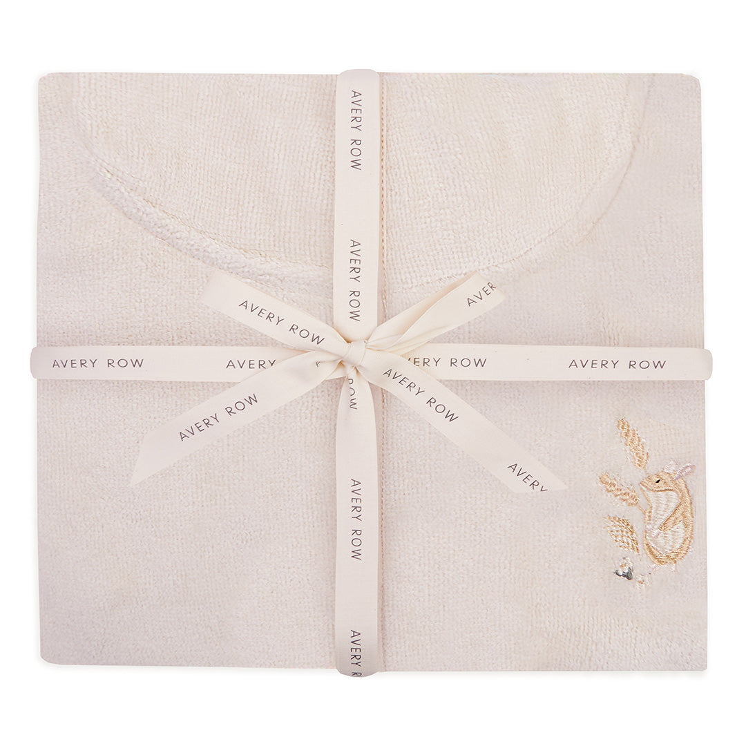 Folded fabric with 'Avery Row' branding and an embroidered design on a white background