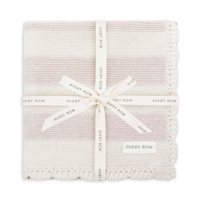 Textured blanket with a white ribbon and 'Avery Row' label on a white background