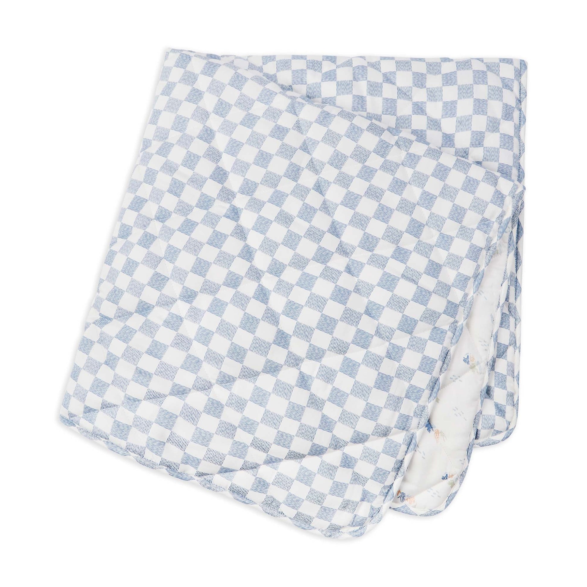 Checkered blanket with blue and white pattern on a white background