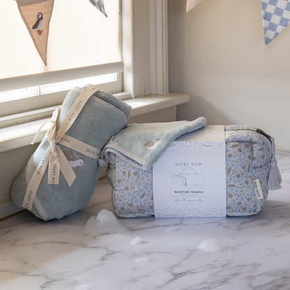 Baby blankets with packaging on a marble surface near a window