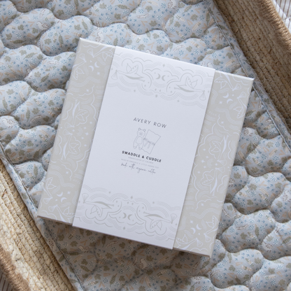 White baby book with embossed design on a textured surface