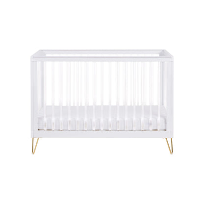 White crib with gold legs on a white background