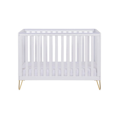 White crib with gold legs on a white background