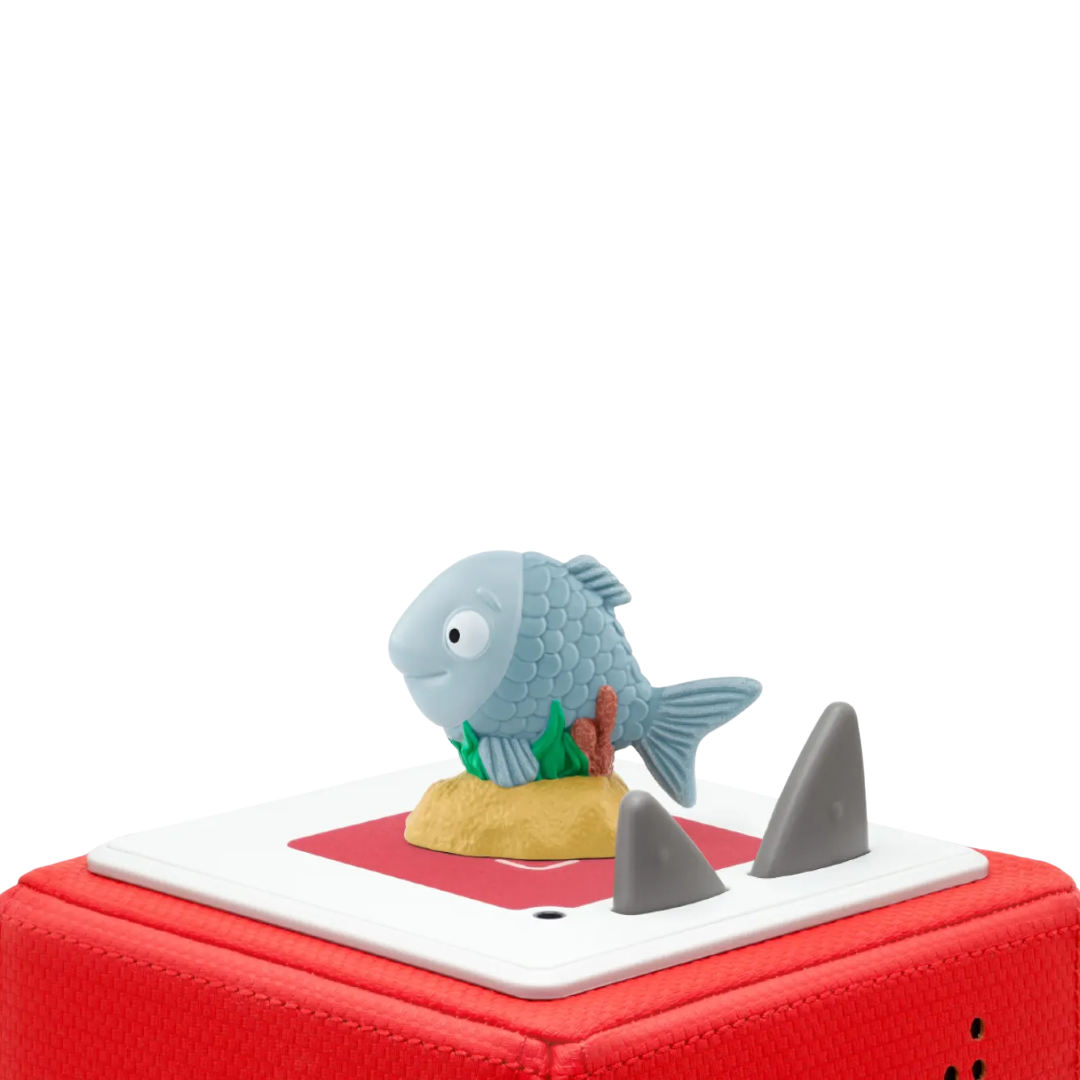 Toy fish on a red base with shark fins on a white background