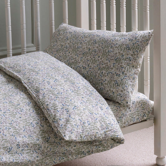 Floral bedding set on a white bed frame