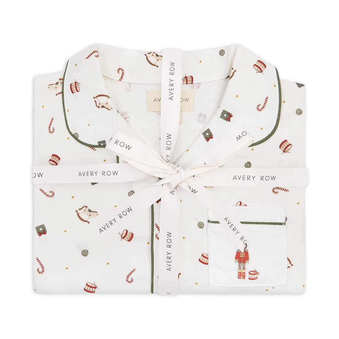 Folded baby outfit with holiday pattern and 'Avery Row' branding on a white background