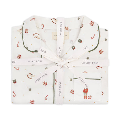 Folded baby outfit with holiday pattern and 'Avery Row' branding on a white background