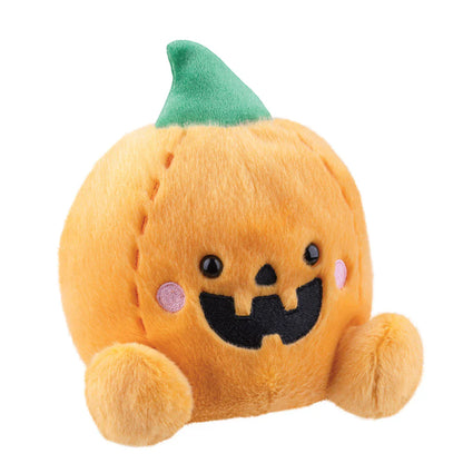 Plush toy pumpkin with a green hat on a white background
