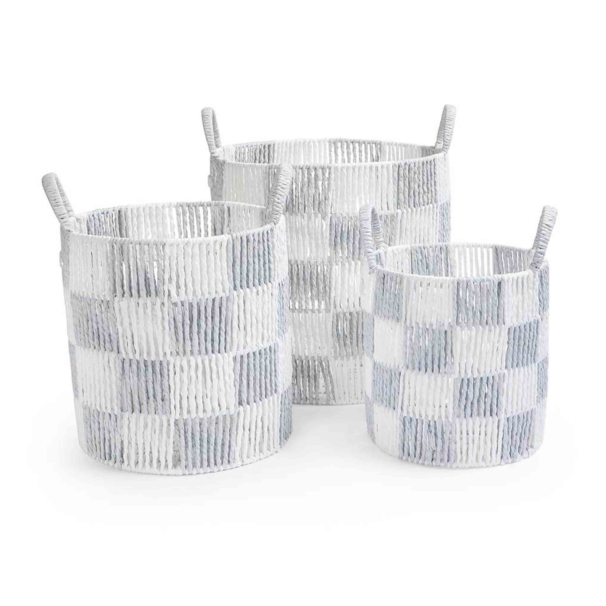 Three woven baskets with a checkered pattern on a white background