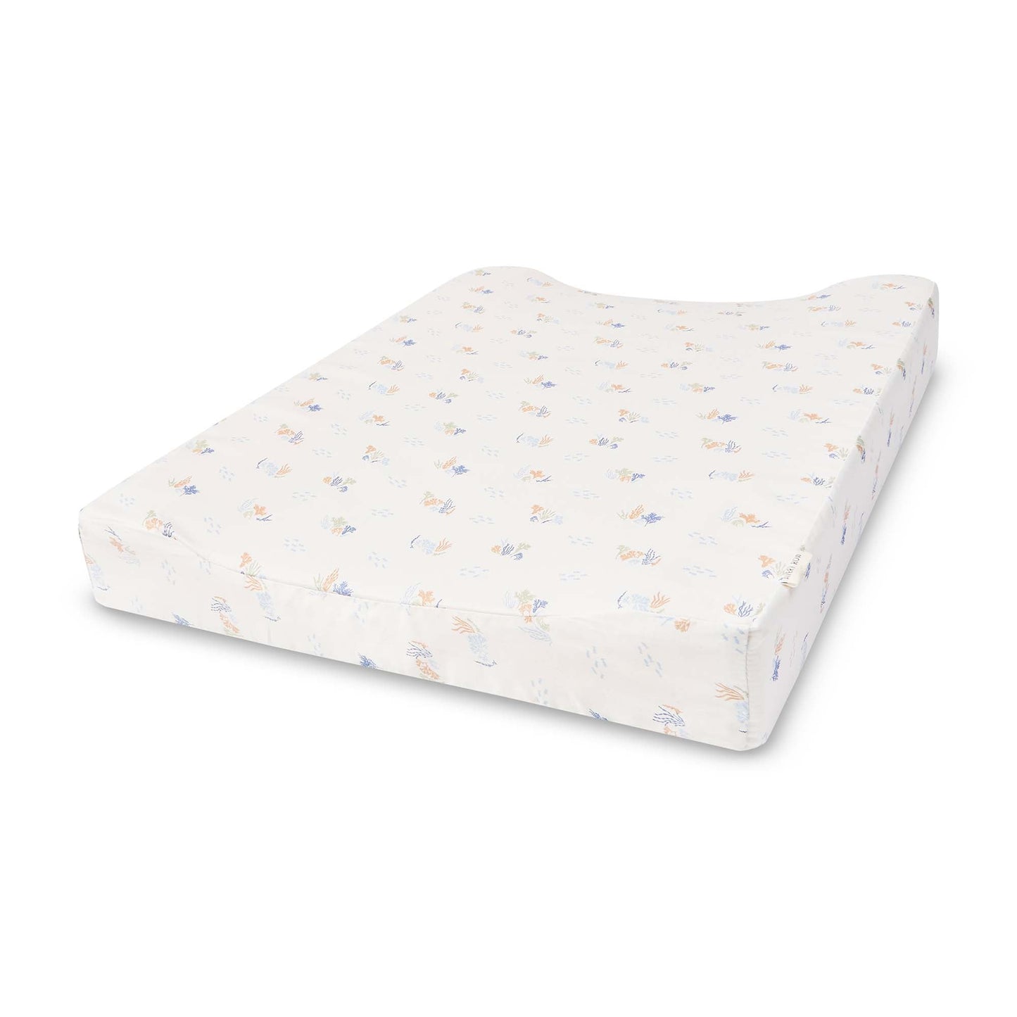 White changing pad with colorful speckles on a white background