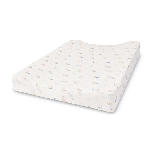 White changing pad with colorful speckles on a white background